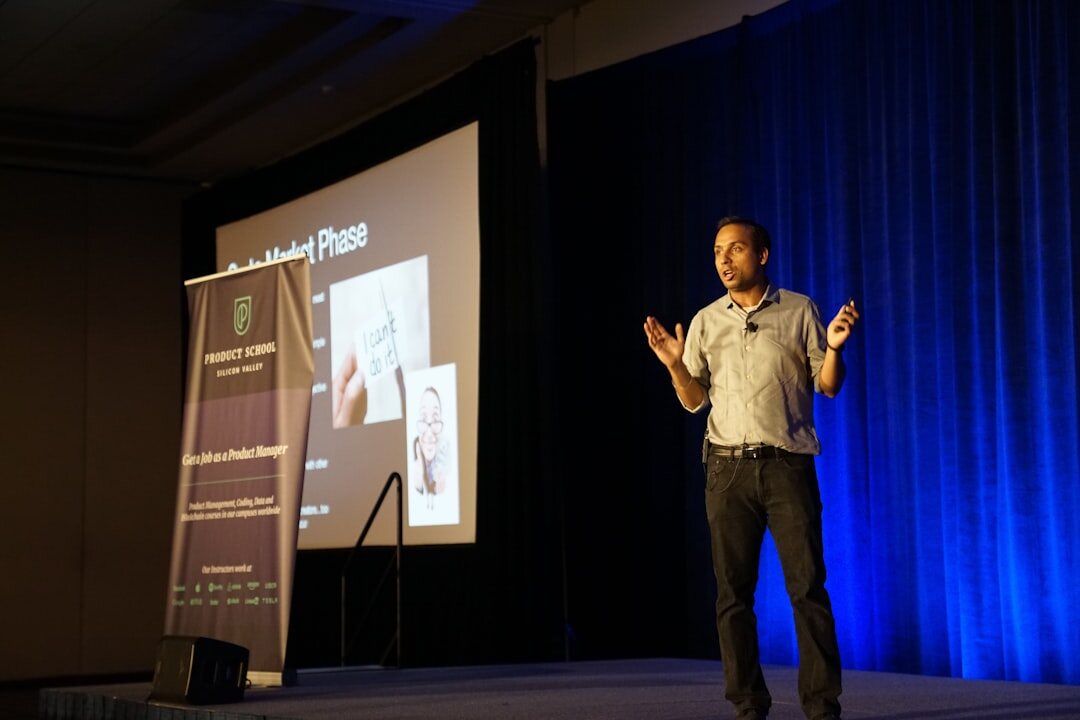 Professional speaker presenting on stage to an audience